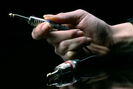 two jacks in hand ready to plug inの写真素材