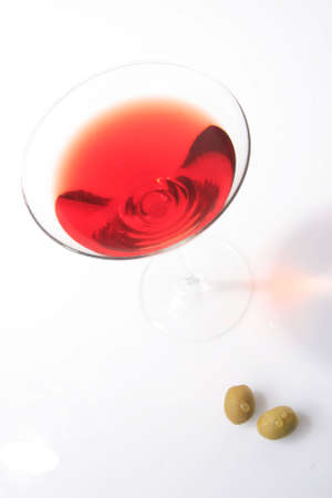 red coctail with two olives standing on whiteの写真素材