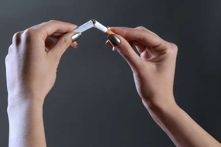 a female hands are breaking the cigaretteの写真素材
