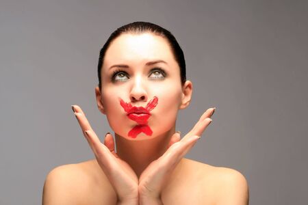 a sensual smart lady with X on her lipsの写真素材