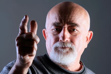 a portrait of a old man with angry faceの写真素材