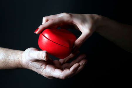 male and female are sharing red heartの写真素材