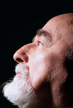 a profile of a senior man on the blackの写真素材