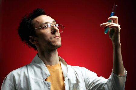 a crazy scientist with new formula on redの写真素材