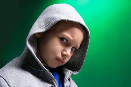 a portrait of a blond boy on greenの写真素材