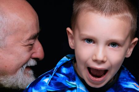 a portrait of a blond boy with his grandpaの写真素材