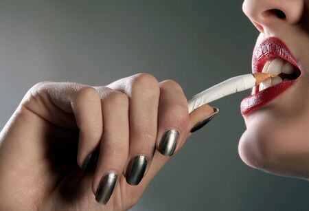  a macro of red lips with cigaretteの写真素材