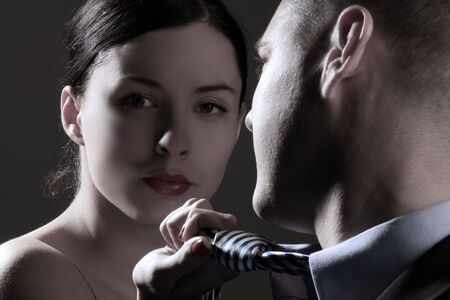 a young business couple on black backgroundの写真素材