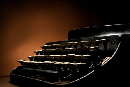 photo of an old typewriter on orangeの写真素材