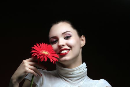 girl is relaxing and holding red fowerの写真素材