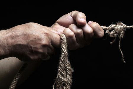 photo of a rope with hand pullingの写真素材