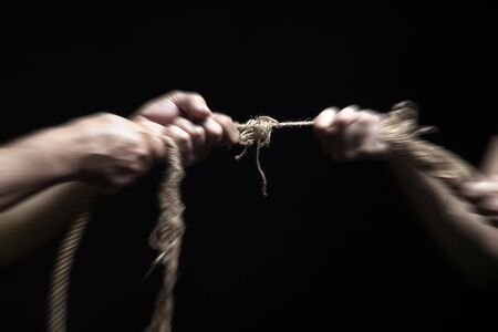 photo of a rope with hand pullingの写真素材