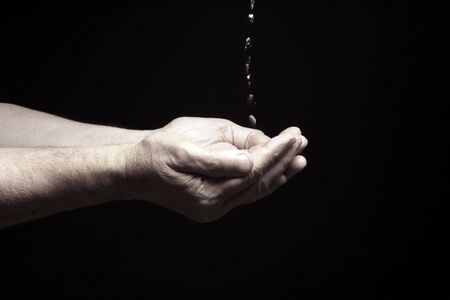 photo of an old male hands with water