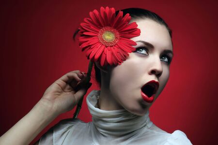 girl is relaxing and holding red flowerの写真素材