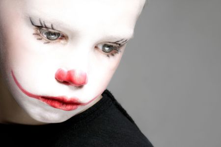 portrait of make up clown boy with red noseの写真素材