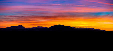 The silhouette  of a mountain in the sunsetの写真素材