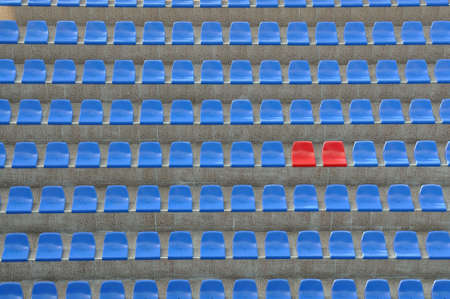 Blue and red seats outdoors in stadiumの写真素材