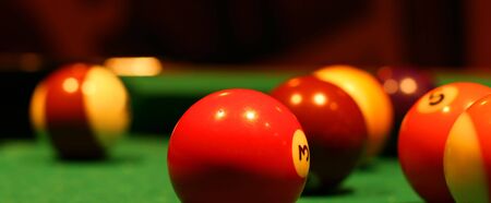 Billiard balls on green broadcloth of the billiard table