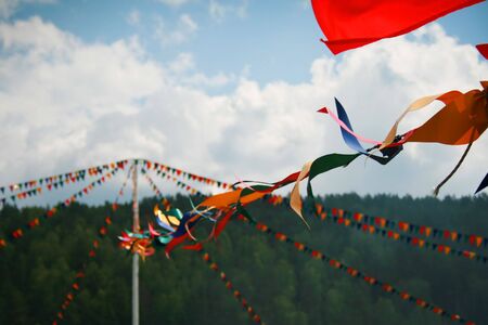Small triangular flags on background blue skyの写真素材