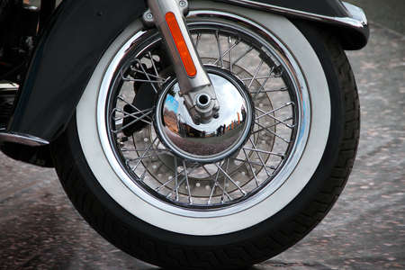 View of a classic American motorcycle standing on a city streetの写真素材