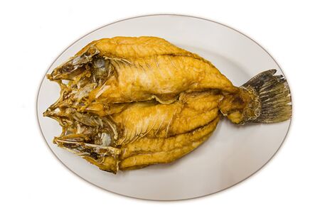 Snapper fish is fried on dish for isolateの写真素材