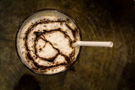 Ice coffee with caramel in glass