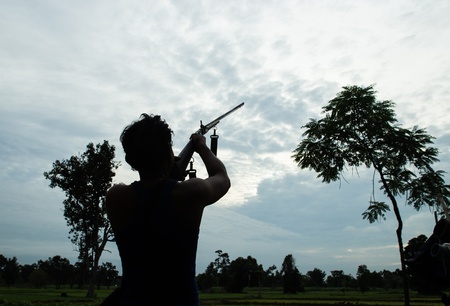 Man shoot gun on skyの写真素材