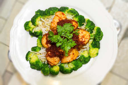 Scallops and broccoli stir fire with spicy sauceの写真素材