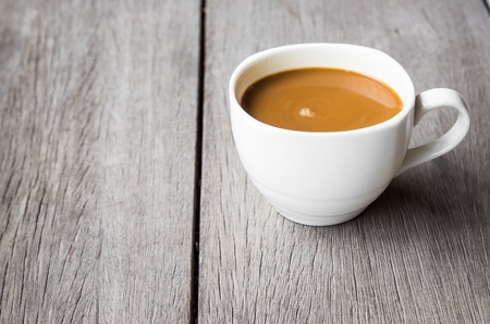 Hot coffee in cup on woodの写真素材