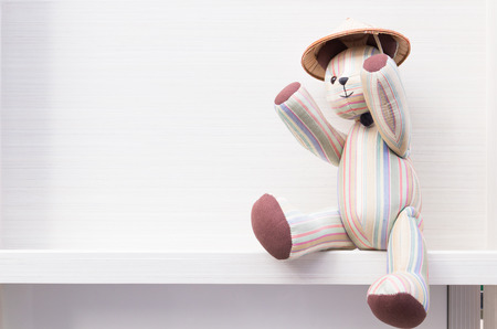 Teddy bear sitting on wallの写真素材