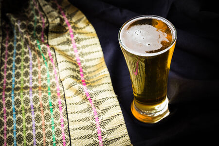 Glass beer on wood background with copyspace