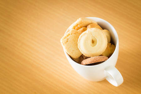 Chip cookies in a cup on wooden table