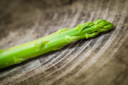 Bunch of fresh green asparagus spears on a rustic wooden tableの写真素材
