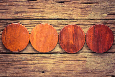 Wood circle cutting board on old wooden backgroundの写真素材