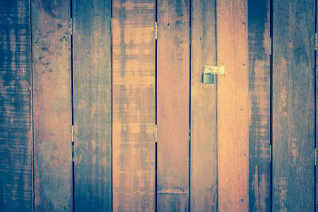 Old weathered wooden door made from planks. With rusty lockの写真素材
