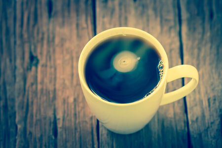 Cup of coffee on old wooden tableの写真素材