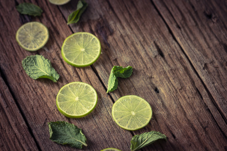 Fresh limes on wooden backgroundの写真素材