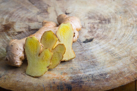 Ginger root sliced on wooden