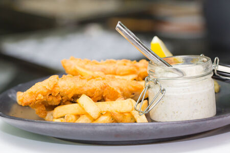 Fish and chips with Tartar sauce on dish