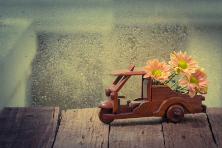 Vintage of colorful flowers decoration on wooden toy carの写真素材