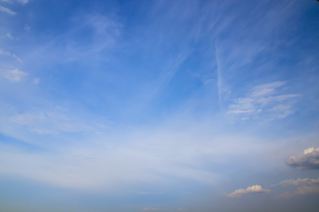 white fluffy clouds in the blue skyの写真素材