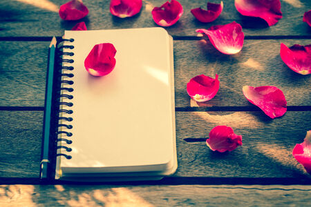 Flower with notebook on deskの写真素材