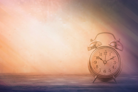 retro alarm clock on table in front the rainの写真素材