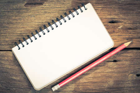 Pencil and a notebook on a table Photo of a Pencil and a notebook on a tableの写真素材