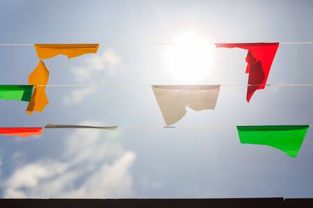 colorful bunting flags against a blue saturated sky