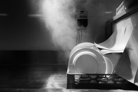 Dishwasher cleaning with heat , photo with monocrome filterの写真素材