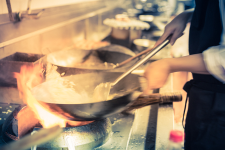 blurred chef of a restaurant kitchen, motion cooking, take photo lowspeedの写真素材