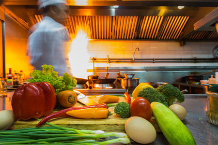 Professional chef motion stir fry cooking with iron pan in the kitchenの写真素材