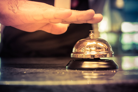 Hand of a man using a hotel bell,vintageの写真素材