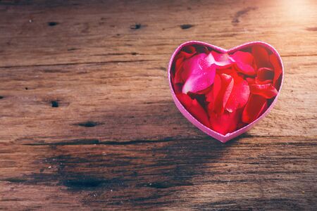 Holiday vintage Valentine`s day background,rose petal in heart boxの写真素材